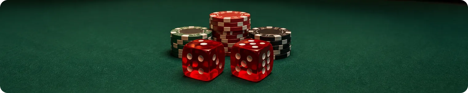 Red dice and casino chips on a craps table