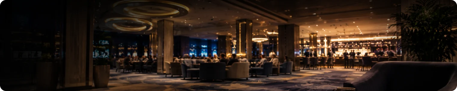 Modern casino lounge with strategy papers on a table and warm bar lighting in the background