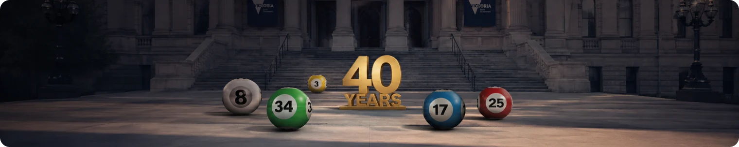 Lottery balls and a 40 Years sign outside a Victorian government-style building symbolising scrutiny of a long-term lottery licence deal