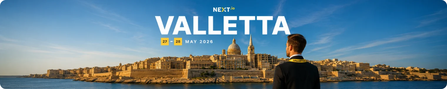Valletta skyline with NEXT.io event text and attendee looking over the harbour